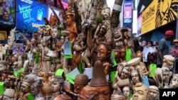 People look at a pile of artworks made out of ivory during a ceremony at the Times Square in New York, June 19, 2015. 