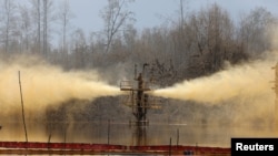 FILE - A view of an oil spill from a well head is pictured at Santa Barbara, in Nembe, Bayelsa, Nigeria, Nov. 25, 2021.
