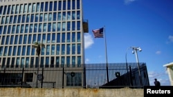 FILE - A security guard stands outside the U.S. Embassy in Havana, Cuba, Dec. 12, 2017.