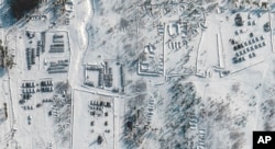 This satellite images provided by Maxar Technologies shows troops gathered at a training ground in Pogonovo, Russia, Jan. 26, 2022.