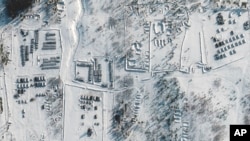 This satellite images provided by Maxar Technologies shows troops gathered at a training ground in Pogonovo, Russia, on Jan. 26, 2022.