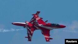 The Surya Kiran Aerobatic Team (SKAT) from the Indian Air Force (IAF) performs during a rehearsal ahead of the Royal Thai Air Force 88th Anniversary at Wing 6 Royal Thai Air Force, in Bangkok, Thailand.