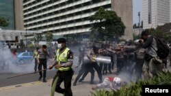 FILE - Police clash with protesters who gathered to rally against Indonesia's rule over the remote eastern Indonesian province of Papua, Dec. 1, 2015. Protesters and police faced off in Jakarta this year.