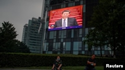 A screen at a department store shows Chinese President Xi Jinping during the opening session of the Chinese People's Political Consultative Conference (CPPCC) at the Great Hall of the People in Beijing, China, May 21, 2020. 
