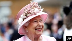 FILE - Britain's Queen Elizabeth arrives for a Royal Garden Party at Buckingham Palace in London, May 29, 2019.