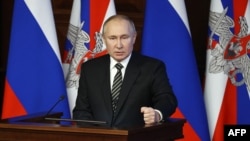 FILE - Russian President Vladimir Putin addresses the annual meeting of the Defense Ministry board in Moscow, Dec. 21, 2021. 