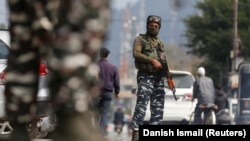 FILE - Indian Central Reserve Police Force personnel stand guard on a street in Srinagar, October 12, 2021.
