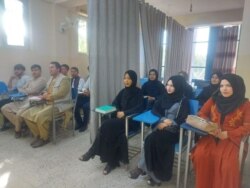 FILE - Students attend class under new gender separation rules, at Avicenna University in Kabul, Afghanistan Sept. 6, 2021, in this picture obtained by Reuters from social media.