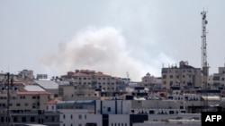 FILE - A picture taken from the Gaza Strip, May 4, 2019, shows smoke billowing after missiles were launched toward Israel. Israel's military said Israeli military said three rockets were fired from Gaza into southern Israel Aug. 17, 2019.