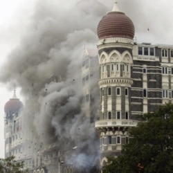 FILE - Smoke billows from the landmark Taj Mahal hotel in Mumbai, India, after an attack by gunmen, Nov. 29, 2008.