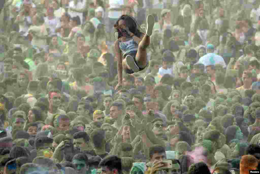 A reveller is tossed in the air during the 6th annual "Day of Colors" in Thermi, near the northern port city of Thessaloniki, Greece, Sept. 10, 2017.