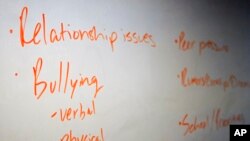 FILE - The board in a classroom is shown with key words during a Youth Aware of Mental Health session at Uplift Hampton Preparatory School in Dallas, Nov. 15, 2018.