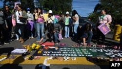 FILE - Women belonging to the feminist collective protest against the rape of girls that occurred in the last few months in San Salvador, on October 18, 2023. 