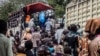 Refugees load their belongings into a UNHCR truck at Ocea Reception Center. According to UNHCR, new refugee sites may have to be opened shortly, with teams already on the ground assessing land suitability. (N. Jidovanu/VOA)