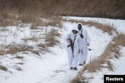 Members of the Ukrainian State Border Guard Service patrol the area near the frontier with Russia in the Chernihiv region, Ukraine, Feb. 16, 2022.