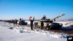 In this photo taken from video and provided by the Russian Defense Ministry Press Service Feb. 15, 2022, Russian army tanks stand in formation after drills in Russia. 