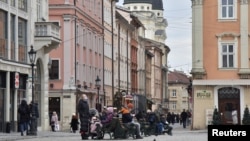 People are seen on a street in central Lviv, Ukraine, Feb. 15, 2022.
