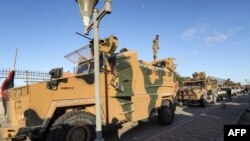 Vehicles of military brigades loyal to the Libyan unity government headed by Abdulhamid Dbeibah arrive from neighboring towns to the capital Tripoli on Feb. 12, 2022.