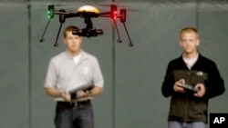 FILE - Students at John D. Odegard School of Aerospace Sciences at the University of North Dakota in Grand Forks, North Dakota, remotely pilot a drone during a demonstration, in a June 24, 2014, photo.