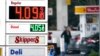 FILE - A driver fills a tank at a gas station in Marysville, Washington, Dec. 10, 2021. Consumer prices rose 6.8% for the 12 months ending in November, a 39-year high.
