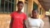 Elizabeth Issa (left) stands with a fellow student outside a school offering classes for pregnant and lactating mothers in Freetown, Sierra Leone, Feb. 22, 2016. (Photo - Nina deVries/VOA) 