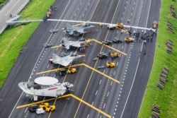In this photo released by Military News Agency, Taiwan war planes are parked on a highway during an exercise in Changhua in southern Taiwan, May 28, 2019.