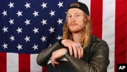 FILE - Hagen Kearney of the U.S. Olympic Winter Games snowboardcross poses for portrait at the 2017 Team USA media summit in Park City, Utah, Sept. 27, 2017.