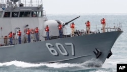 FILE - In this file photo taken May 4, 2019, Taiwan marines salute to Taiwan's President Tsai Ing-wen during an offshore anti-terrorism drill off New Taipei City, Taiwan.