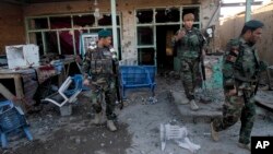 Afghan security forces assess damage after clashes between Taliban fighters and Afghan forces at Kandahar Airfield, Afghanistan, Dec. 9, 2015.