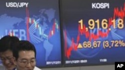 File - Currency traders react in front screens at the Korea Exchange Bank headquarters in Seoul, South Korea.