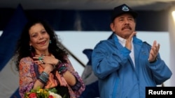 FILE - Nicaraguan President Daniel Ortega and Vice President Rosario Murillo greet supporters in Managua, Nicaragua, Oct. 13, 2018.