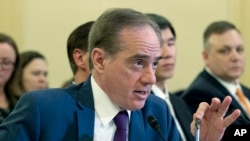FILE - Then-Veterans Affairs Secretary David Shulkin testifies before the Senate Committee on Veterans Affairs on Capitol Hill, in Washington, March 21, 2018. Shulkin is blaming his sudden ouster from the Trump administration on ''political forces'' that he says are bent on privatizing the agency.