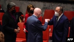 Permanent Representative of the Russian Federation to the UN Vasily Nebenzya (C) fist bumps Ambassador Zhang Jun, Permanent Representative of China, as US ambassador Thomas-Greenfield and Permanent Representative of Norway Mona Juul look on, Feb. 21, 2022.