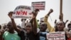 Protesters hold signs calling for an end to homosexuality in Senegal in Dakar, Feb. 20, 2022. (Annika Hammerschlag/VOA)