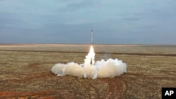 This photo taken from video provided by the Russian Defense Ministry Press Service Feb. 19, 2022, shows a Russian Iskander-K missile launched during a military exercise at a training ground in Russia. 