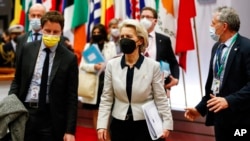 FILE - European Commission President Ursula von der Leyen leaves at the end of an EU summit on Ukraine in Brussels, Feb. 25, 2022. 