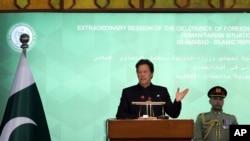 FILE - Pakistan Prime Minister Imran Khan, center, speaks during the extraordinary session of Organization of Islamic Cooperation Council of Foreign Ministers, in Islamabad, Pakistan, Dec. 19, 2021. 