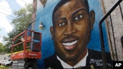 FILE - This May 17, 2020, photo shows a mural depicting Ahmaud Arbery in Brunswick, Ga.