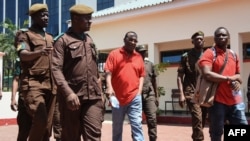 Tanzania's main opposition Chadema party leader Freeman Mbowe (center, in red shirt) arrives at the High Court in Dar es Salaam, Tanzania, Feb. 18, 2022.