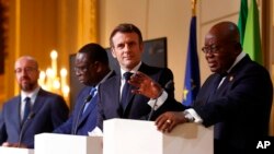 French President Emmanuel Macron, second right, listens to Ghana's President Nana Afuko Addo, right, with Senegal's President Macky Sall, and European Council President Charles Michel, left, during a joint press conference in Paris on Feb. 17, 2022.