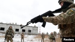 FILE - Reservists of the Ukrainian Territorial Defense Forces take part in military exercises on the outskirts of Kyiv, Jan. 29, 2022. 
