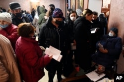 People from Donetsk, the territory controlled by a pro-Russia separatist government in eastern Ukraine, gather to fill in documents after evacuating in the Rostov-on-Don region, near the border with Ukraine, Russia, Feb. 20, 2022.
