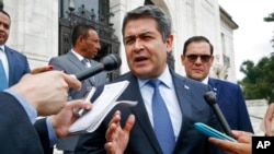FILE - Honduran President Juan Orlando Hernandez answers questions from the media, Aug. 13, 2019, in Washington.