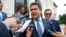 FILE - Honduran President Juan Orlando Hernandez answers questions from the media, Aug. 13, 2019, in Washington.