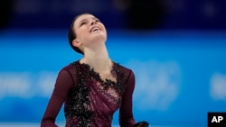 Anna Shcherbakova of the Russian Olympic Committee smiles after competing in the women's free skate program during the figure skating competition at the 2022 Winter Olympics, Feb. 17, 2022, in Beijing.