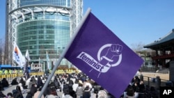 People stage a rally supporting feminism in Seoul, South Korea, Feb. 12, 2022.
