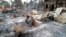 FILE - Charred homes sit in piles of ash in Mwe Tone village of Pale township in the Sagaing region, Myanmar, Feb. 1, 2022. 