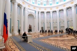Russian President Vladimir Putin, left, chairs a Security Council meeting in the Kremlin in Moscow, Russia, Feb. 21, 2022.