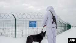 A Ukrainian frontier guard patrols along the border with Russia, some 40 kilometers from the Ukrainian city of Kharkiv, on Feb. 16, 2022. 