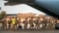 FILE - French Barkhane force soldiers leave their base on a transport plane in Gao, Mali, June 9, 2021, having completed a tour of duty. French President Emmanuel Macron announced at a press conference Feb. 17, 2022, that he is withdrawing French forces from the country.